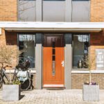 The facade of a brick building with wooden door KTK Home Boutique